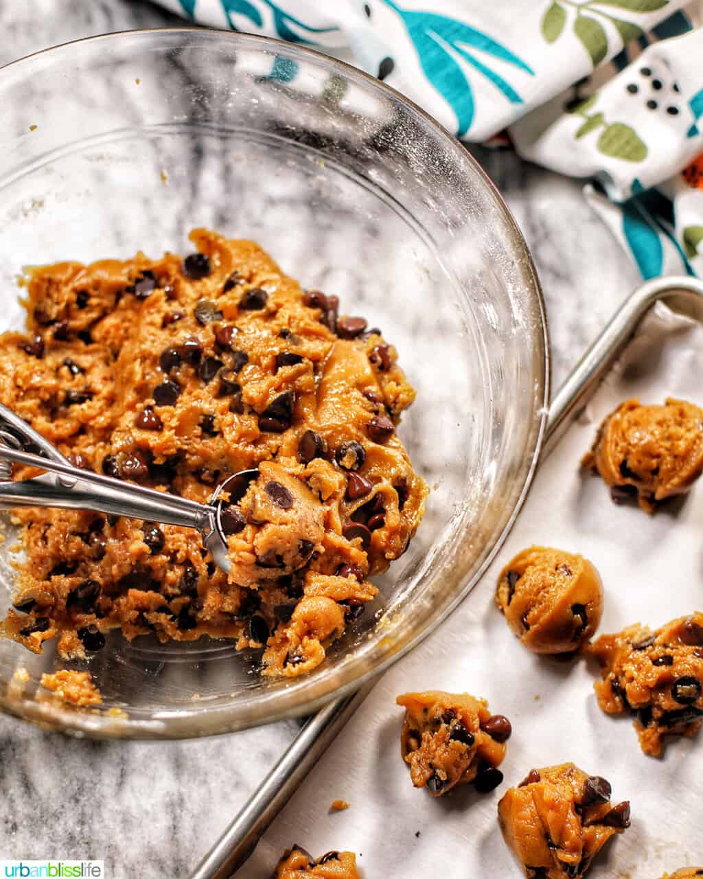 scooping cookie batter onto baking sheet
