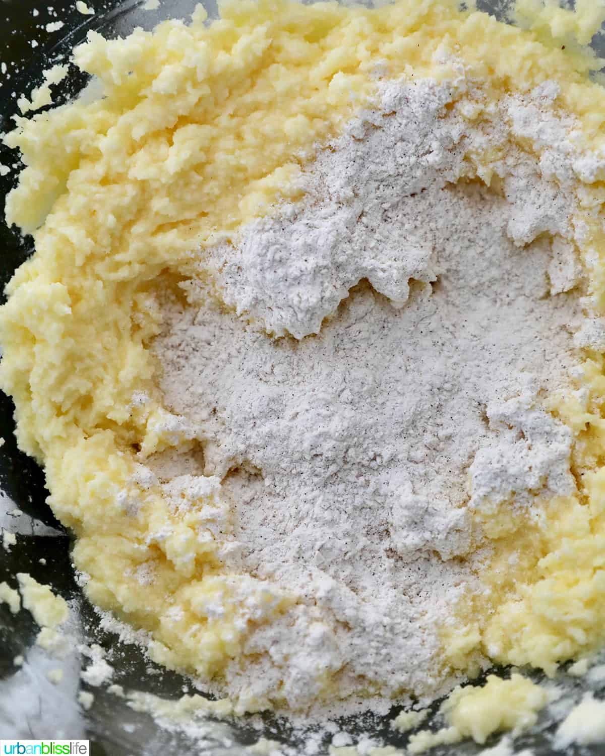 adding dry ingredients to wet ingredients.