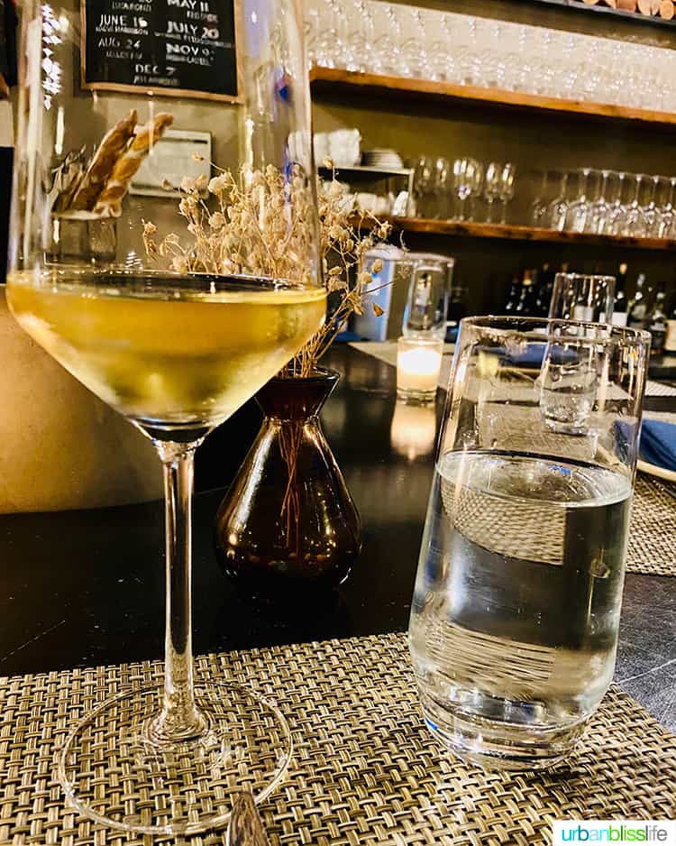 glass of white wine on a table at Arden wine bar.