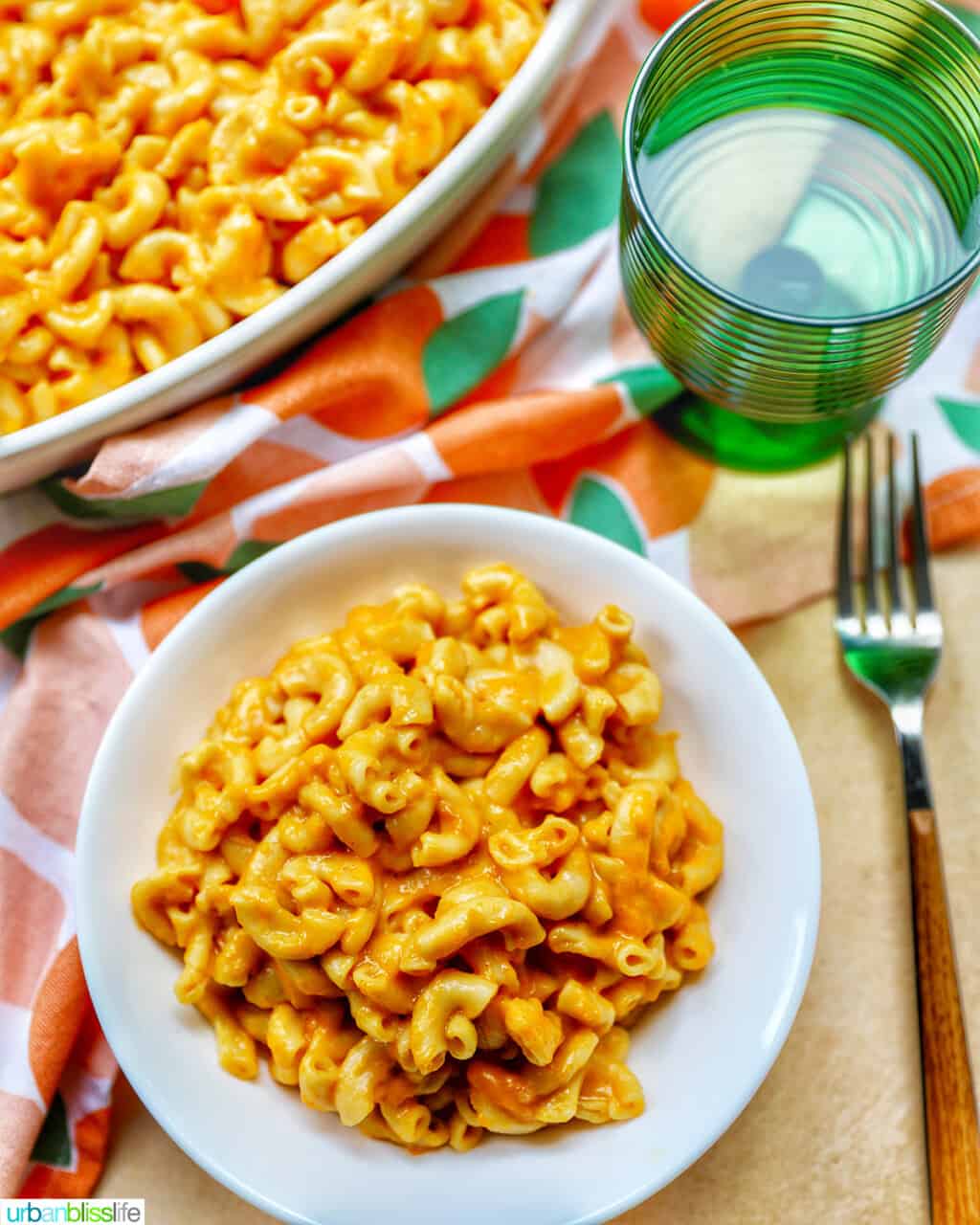 bowl of butternut squash mac and cheese with green glass