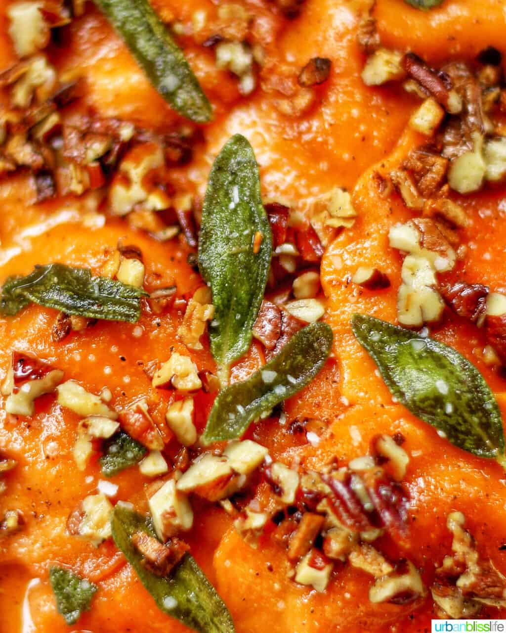 closeup of crispy sage and pecans on butternut squash ravioli