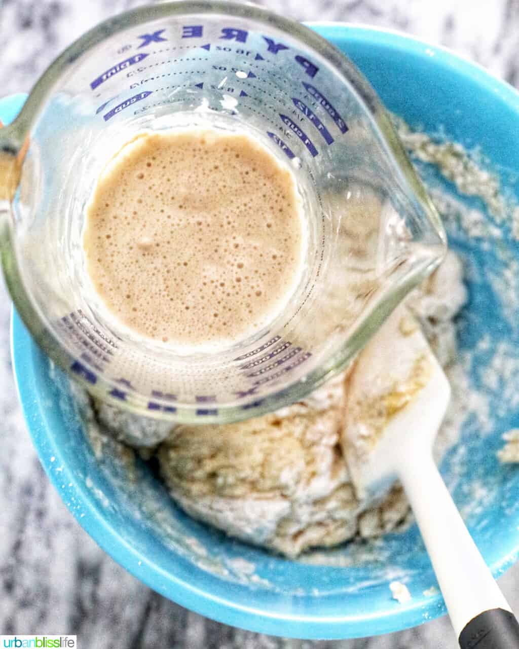 adding active yeast mixture to pandesal dough