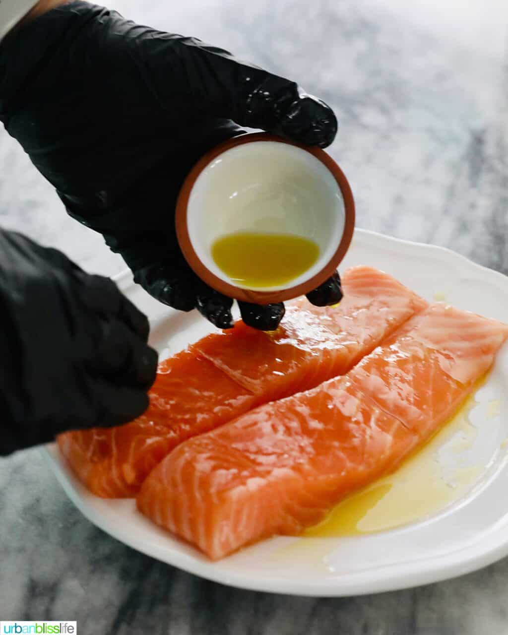 rubbing olive oil onto salmon