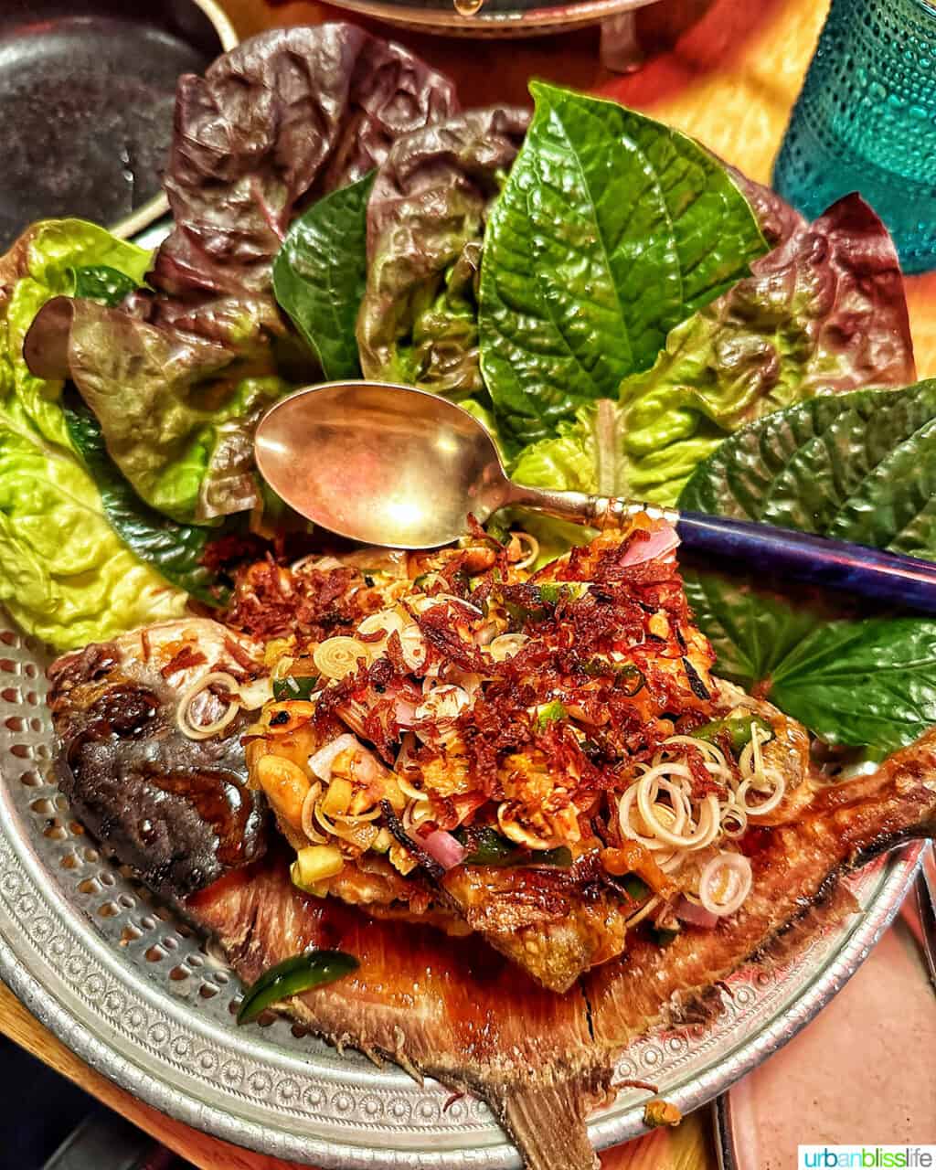 Whole fried fish and salad leaves at Phuket Cafe.