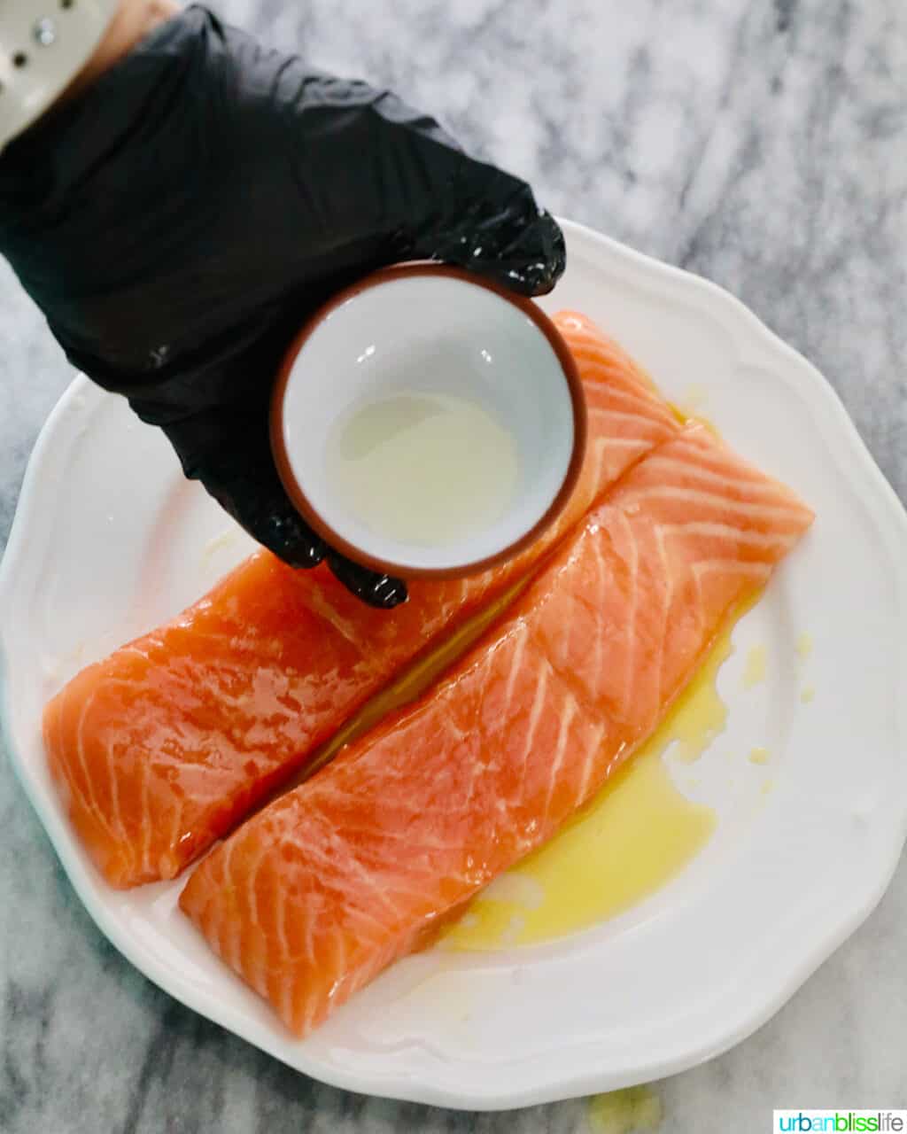 rubbing lemon juice over salmon fillets