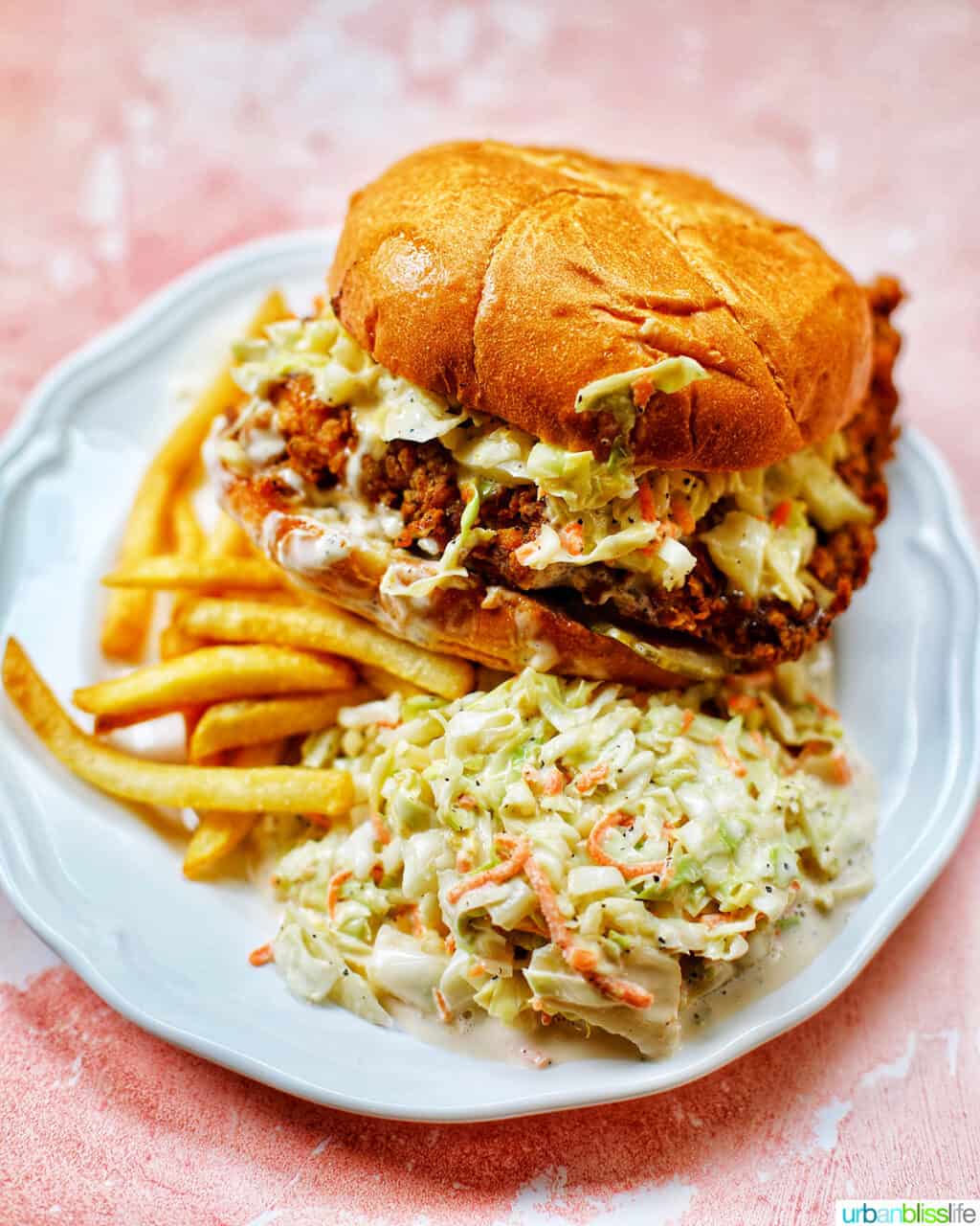 fried chicken sandwich with fries and slaw.