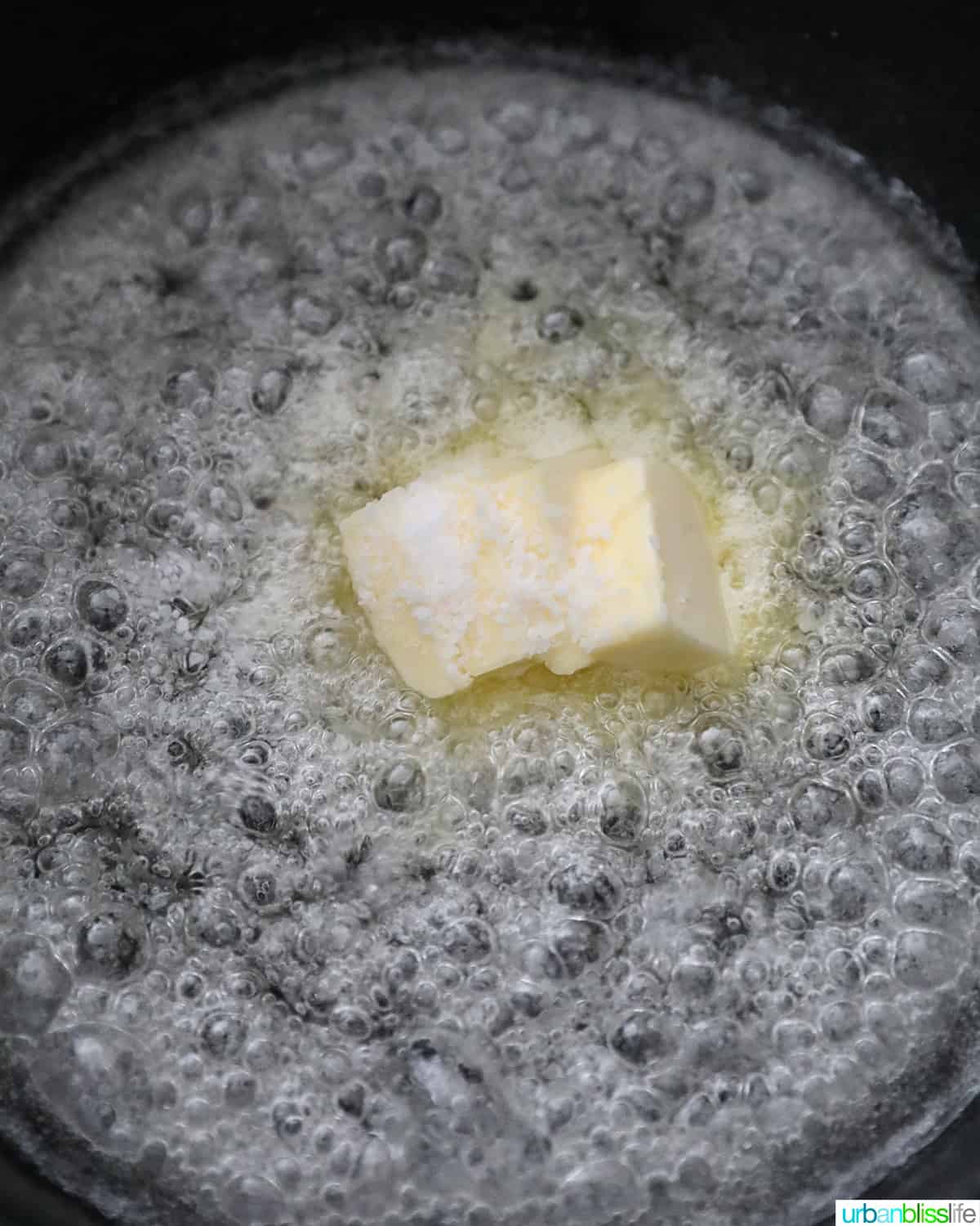 adding butter to sugar for caramel