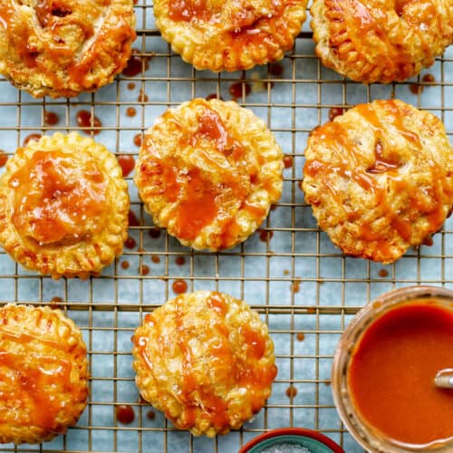 Air fryer apple hand pies on a rack with caramel