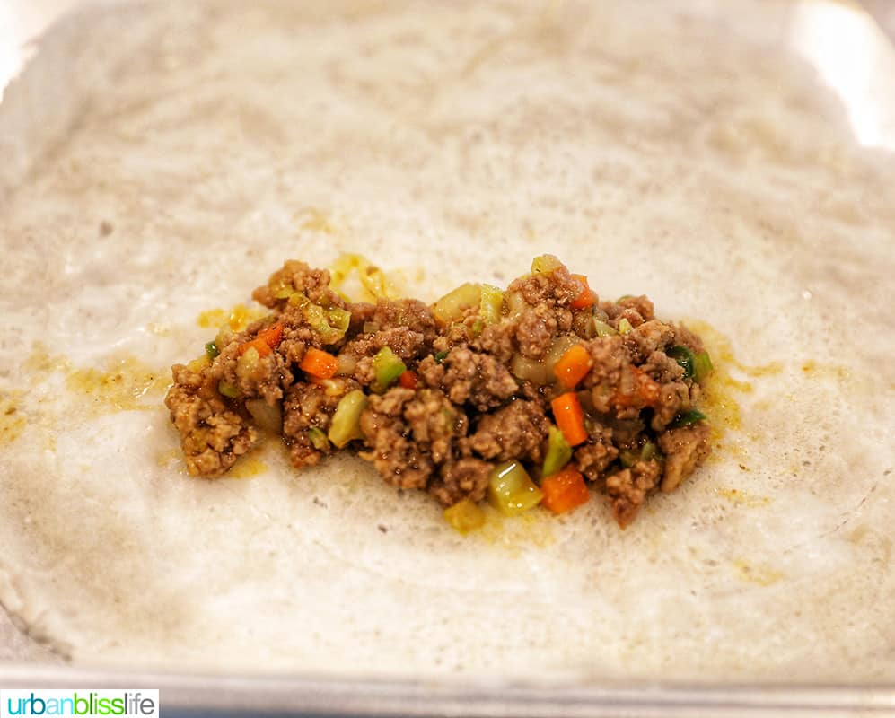 adding the filling to lumpia wrappers