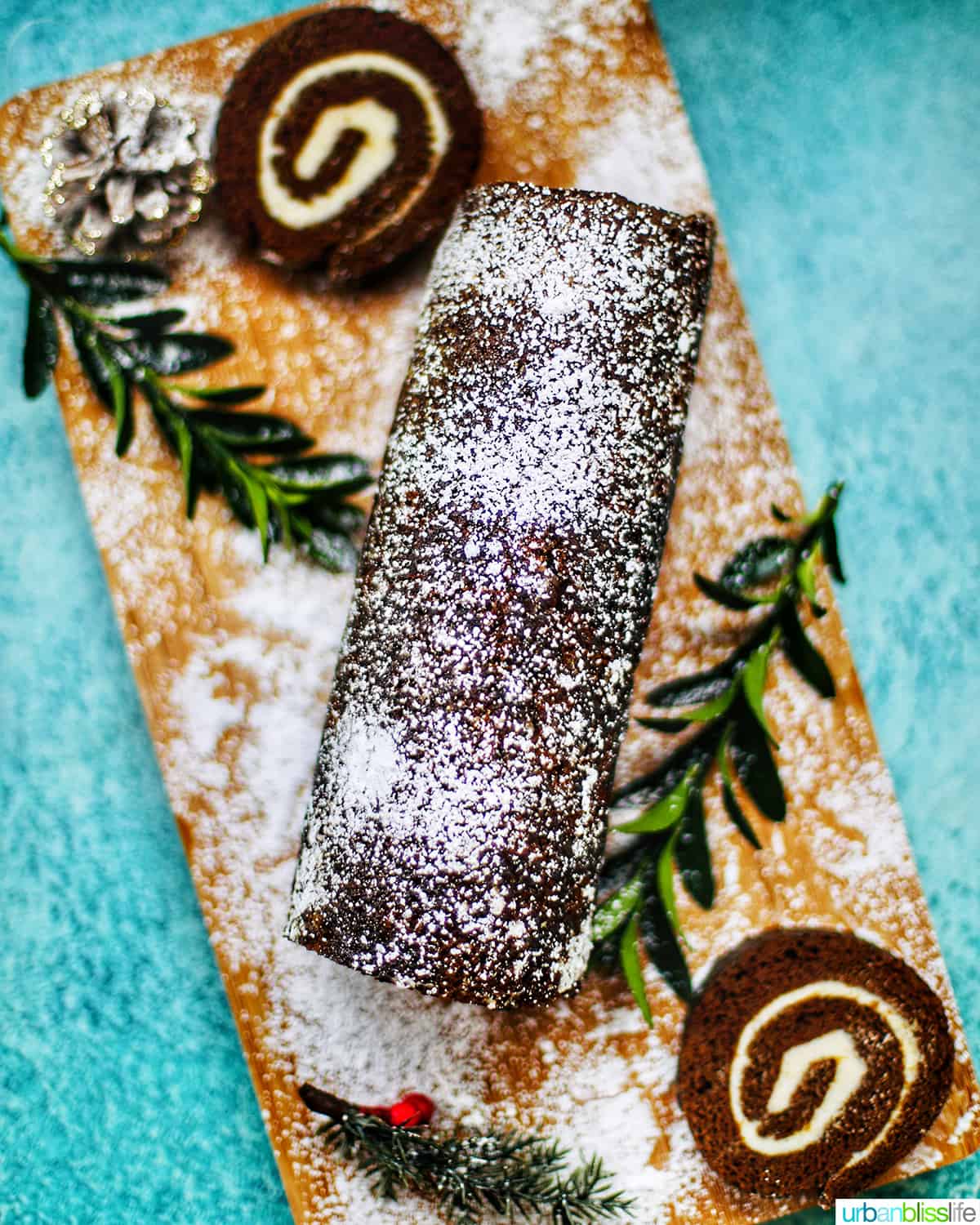 Gingerbread cake roll with holiday trimmings, cream cheese filling, and Christmas decorations.