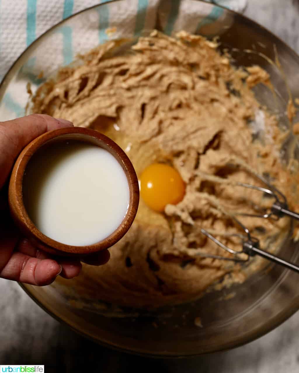 adding milk to cookie batter