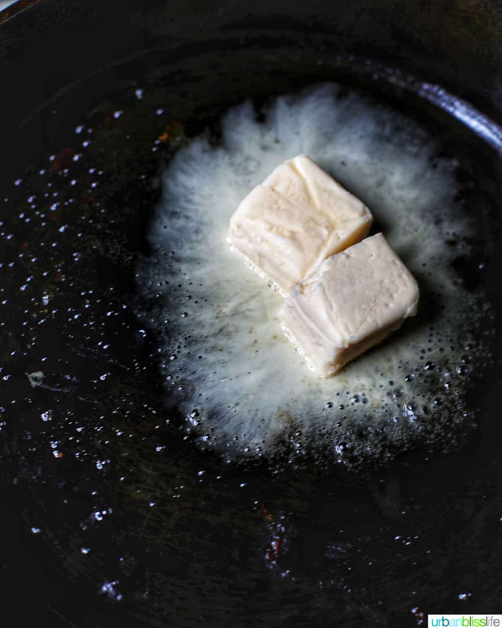 adding butter to a pan