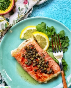 prosciutto wrapped halibut on a green plate