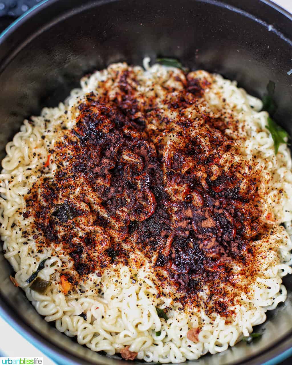 adding spices to ramen and udon noodles to make ram-don (Jjapaguri noodles)