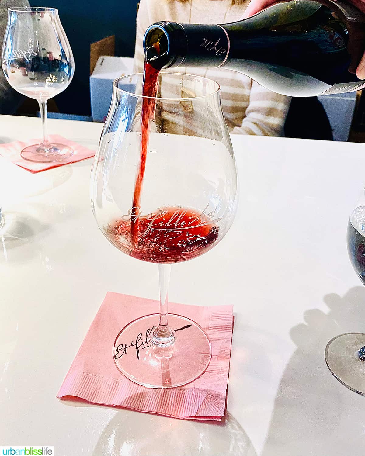 Et Fille red wine pouring into glass
