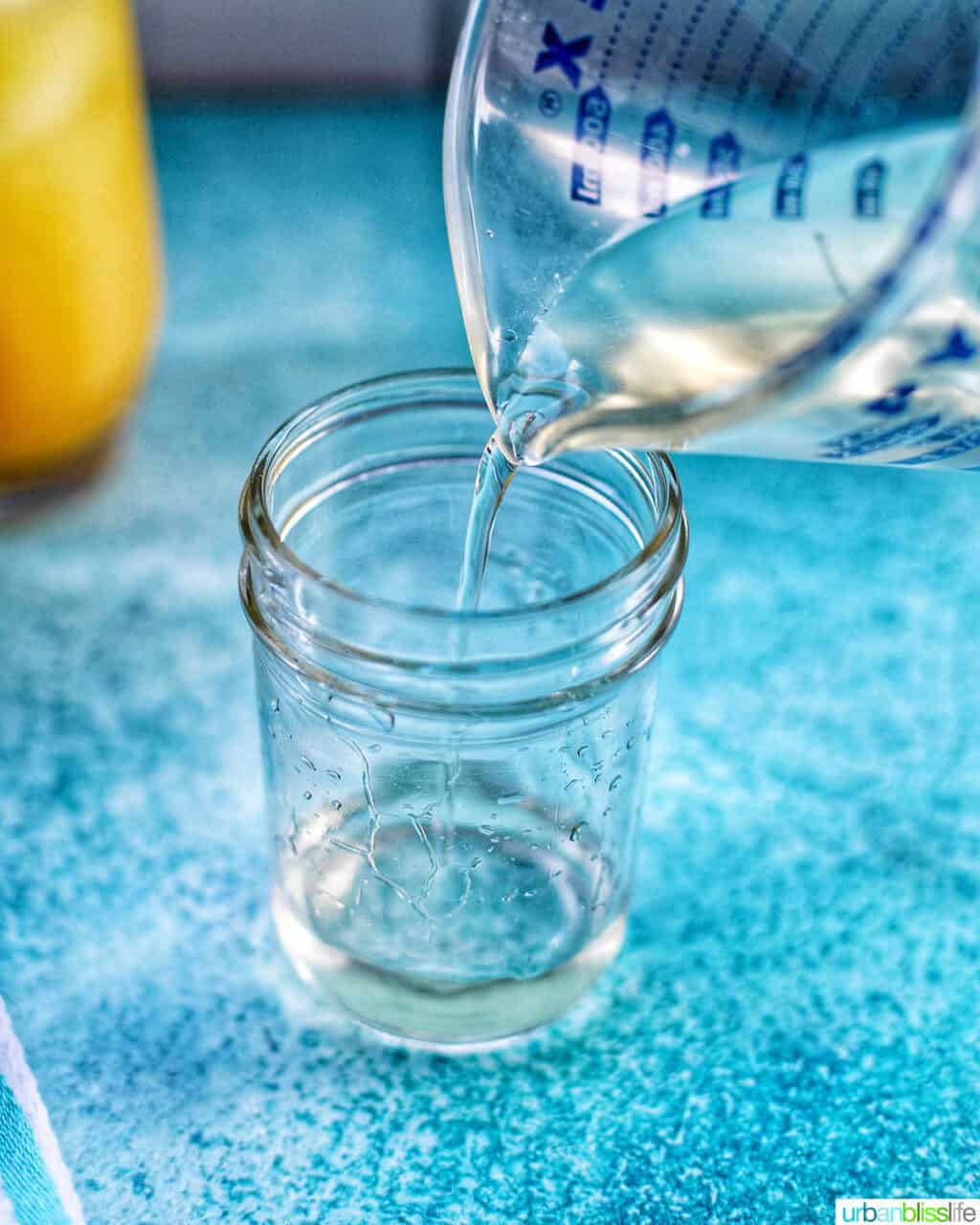 pouring simple syrup into a jar
