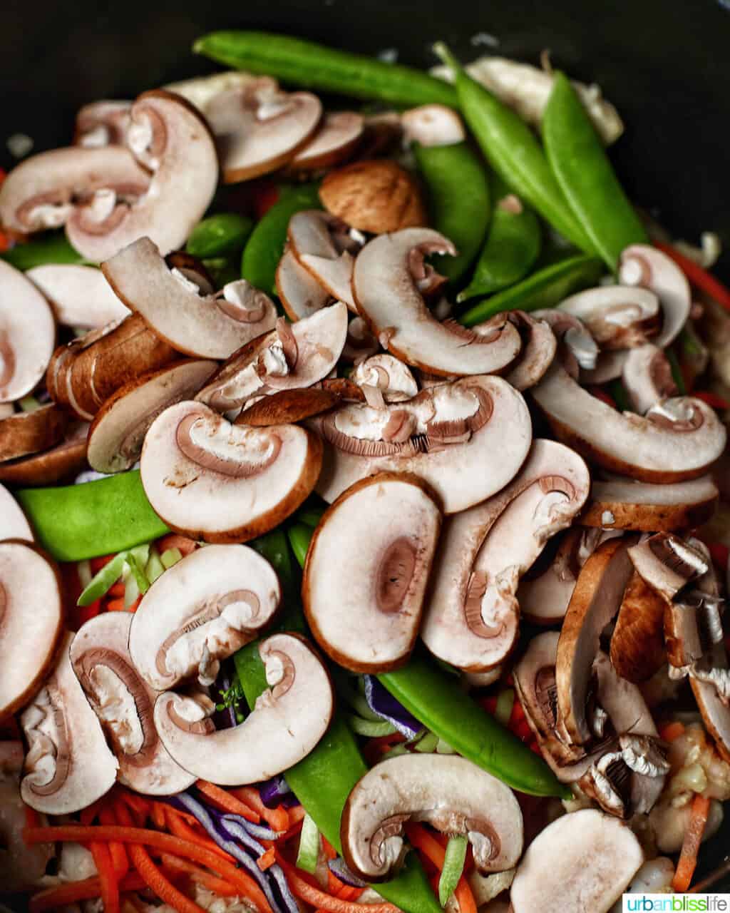adding mushrooms to adding shrimp to Filipino pancit canton noodles