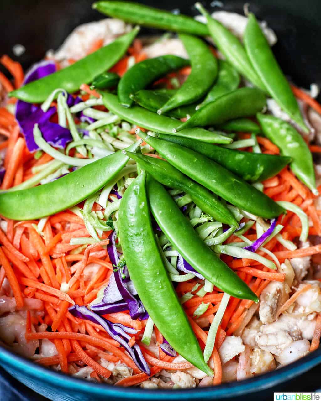adding sugar snap peas to adding shrimp to Filipino pancit canton noodles
