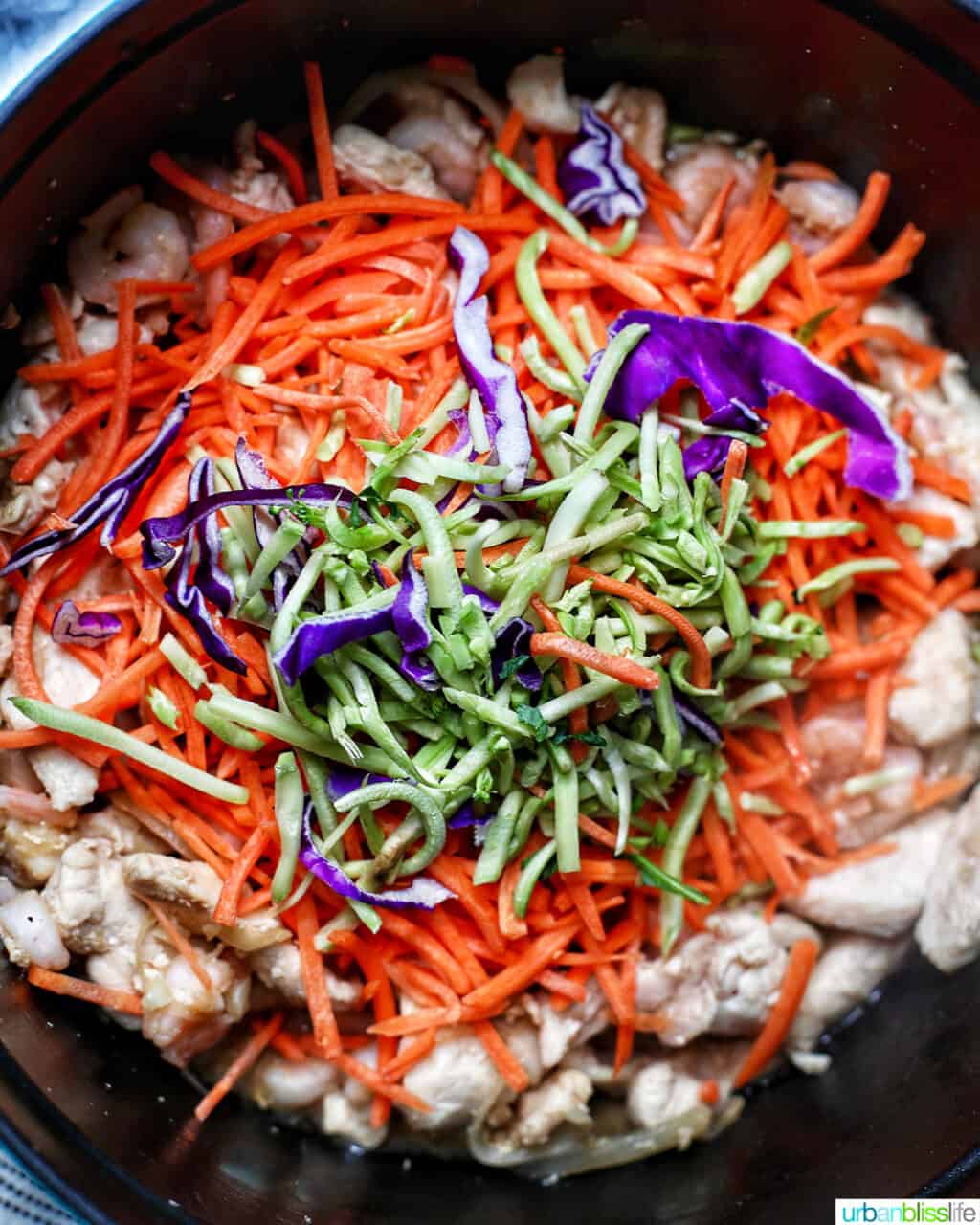 adding cabbage to adding shrimp to Filipino pancit canton noodles