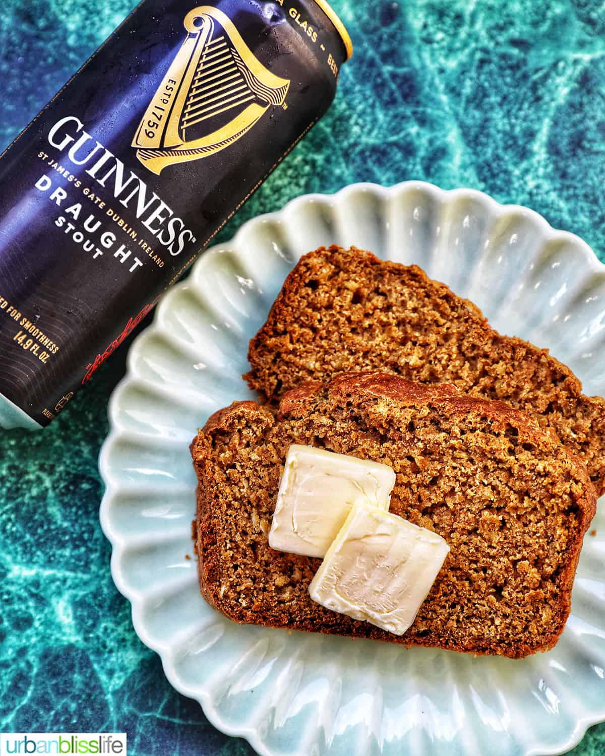 slices of Guinness brown bread with pats of butter and a Guinness beer