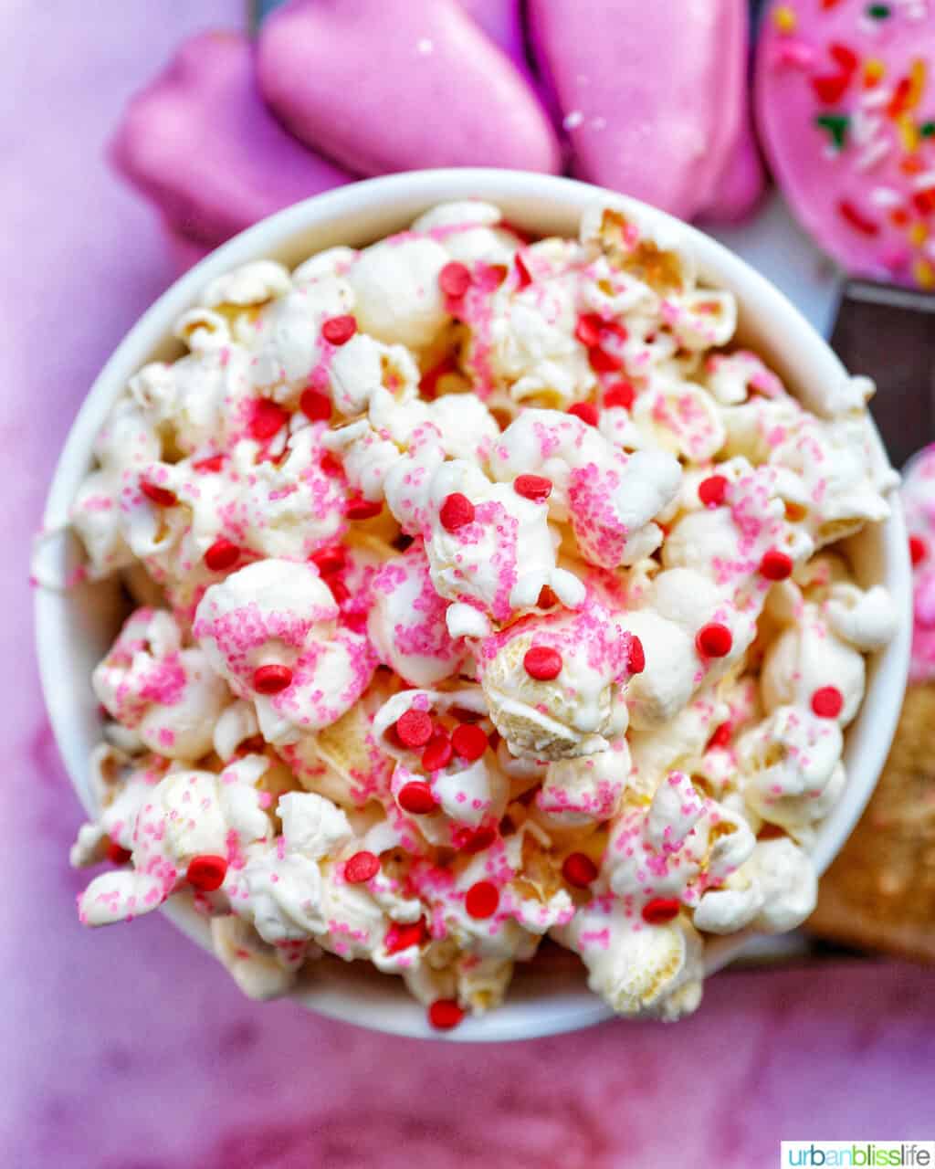 Valentines Day Popcorn in a bowl with pink background