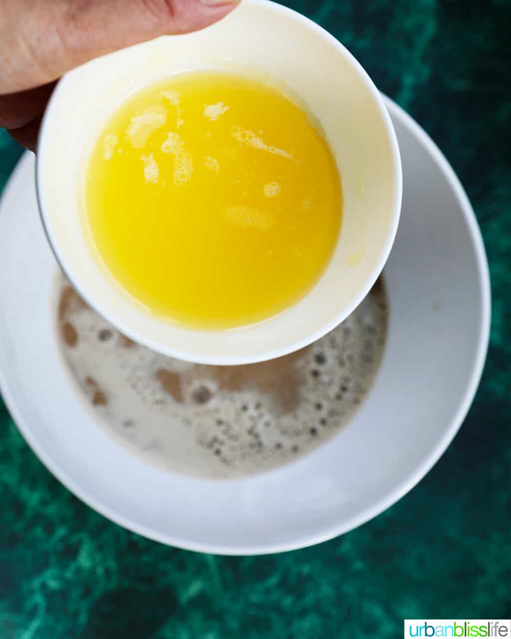 adding melted butter to bread batter
