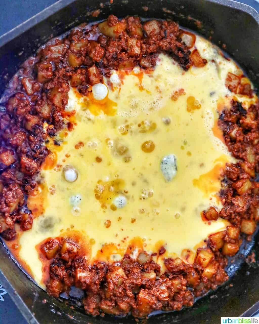 adding eggs to chorizo mix