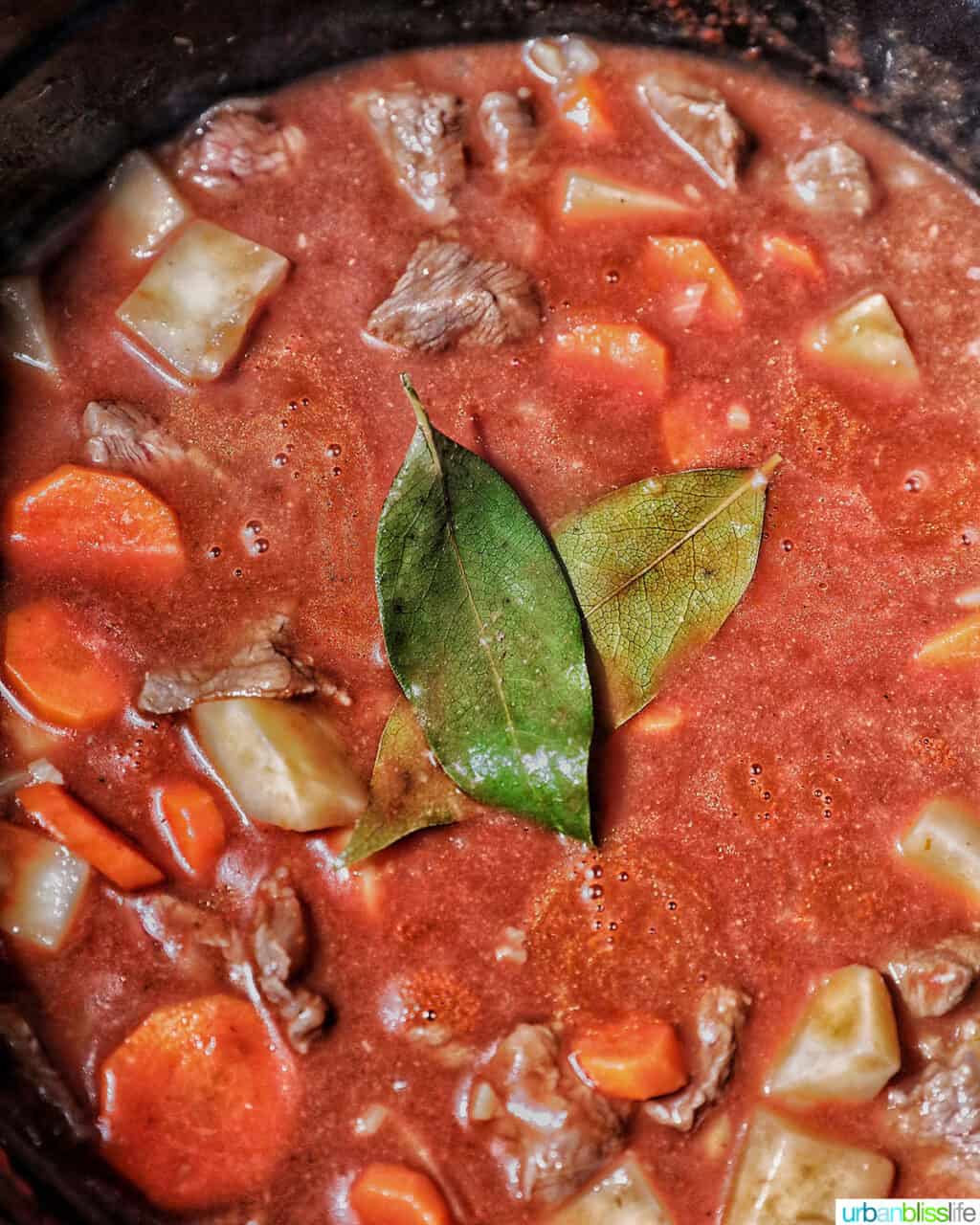 adding bay leaves to beef caldereta