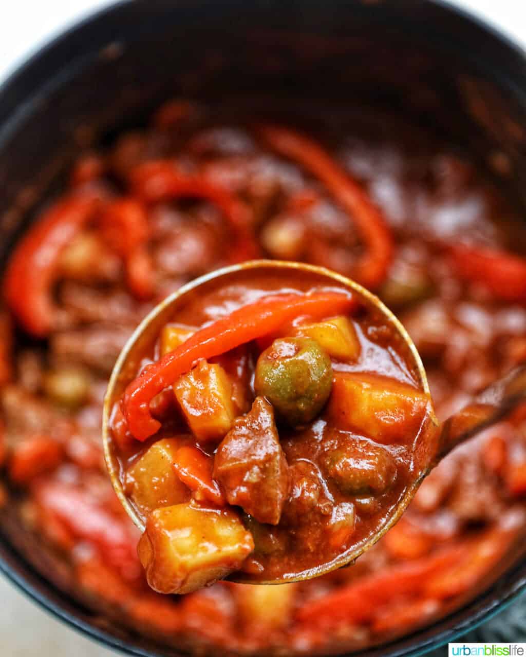 ladle of beef caldereta over pot