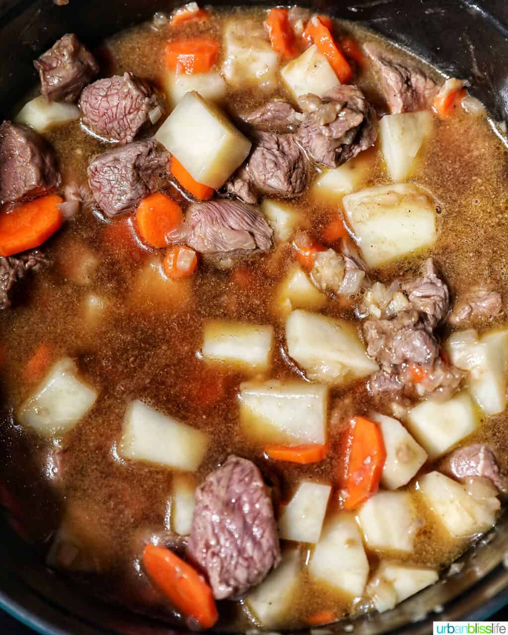 adding beef broth to beef caldereta