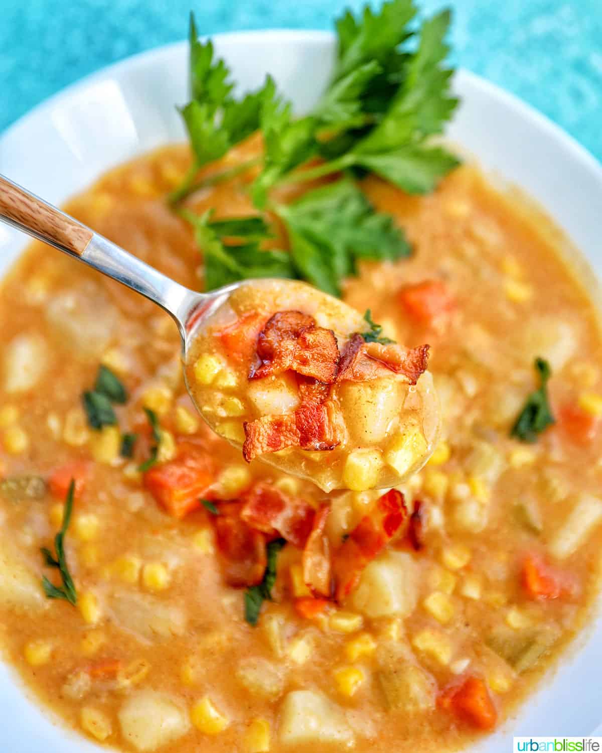spoonful of Instant Pot Potato Corn Chowder in a white bowl.