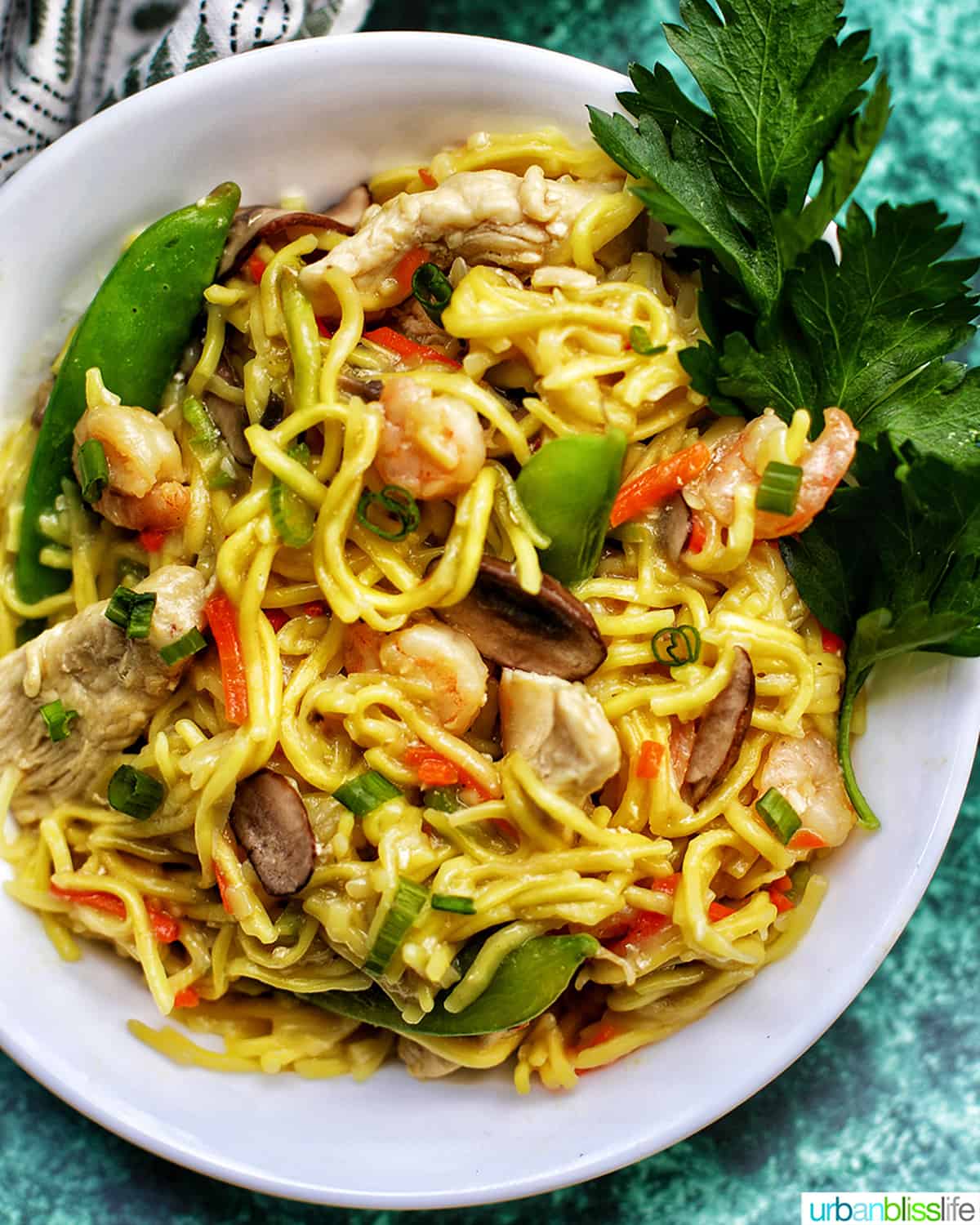 bowl of Filipino Pancit Canton Noodles with shrimp and vegetables.