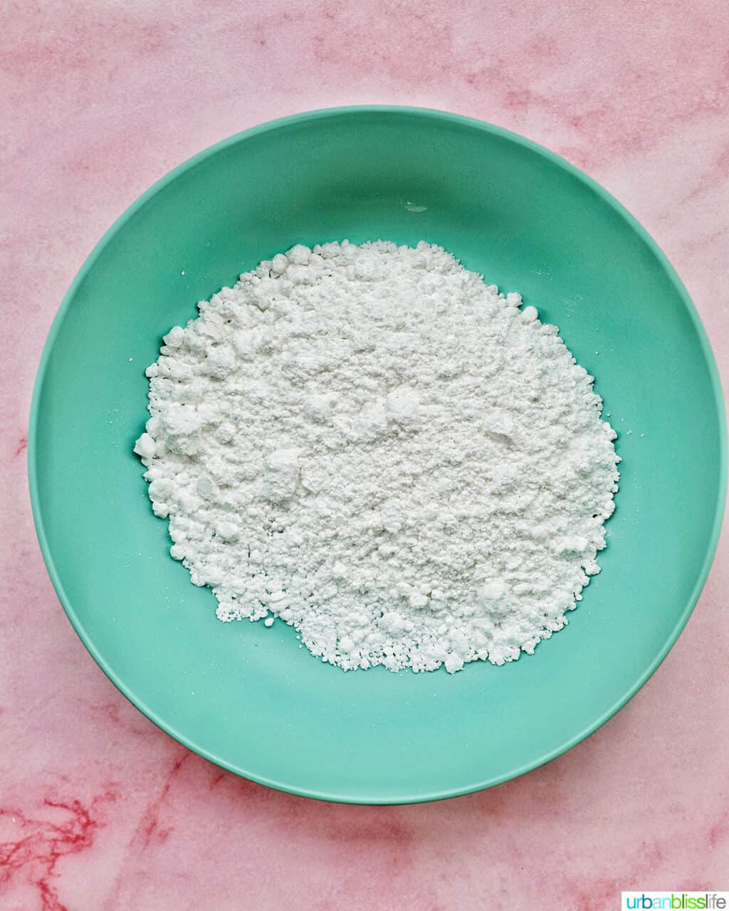 green bowl with powdered sugar