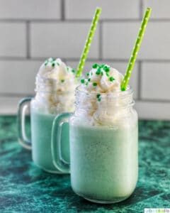 shamrock shake in two glasses on green and white background