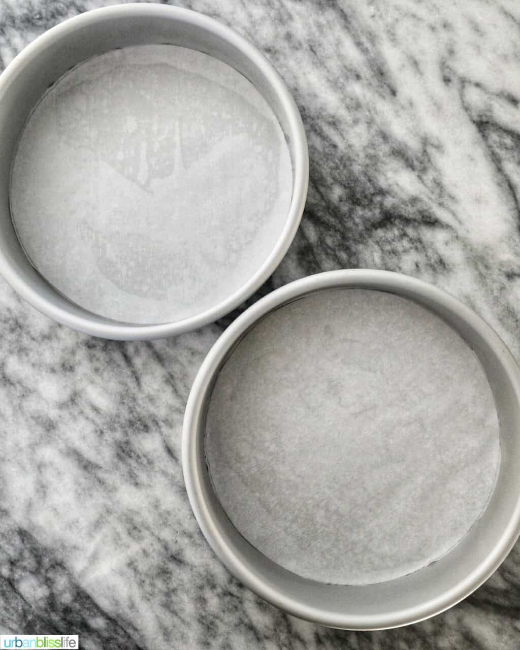two cake pans lined with parchment paper