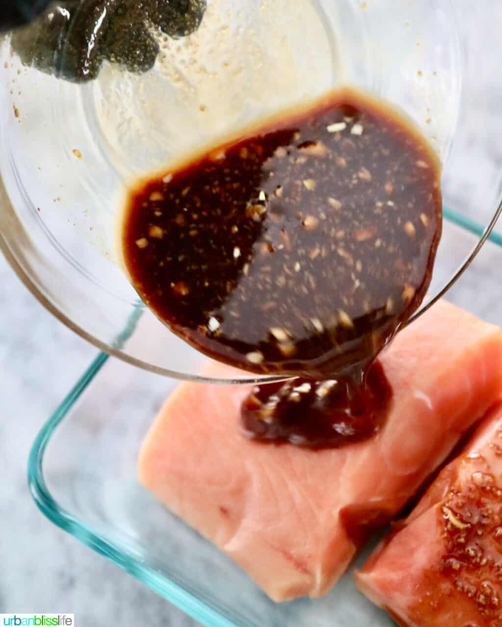 pouring marinade sauce over salmon