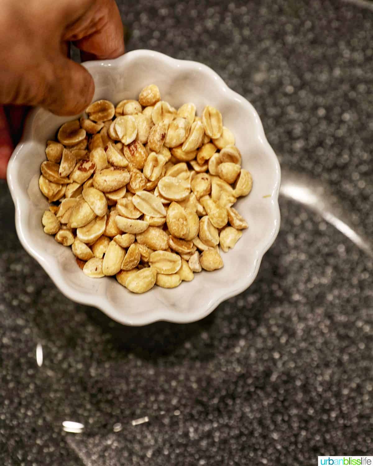 adding peanuts to pan