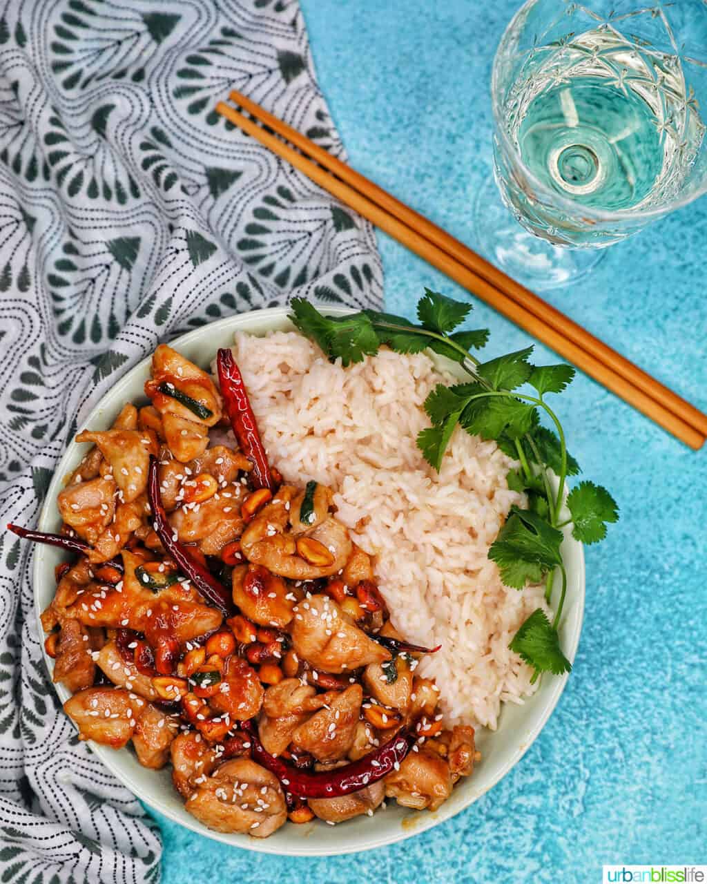 Kung Pao Chicken with rice, chopsticks, wine