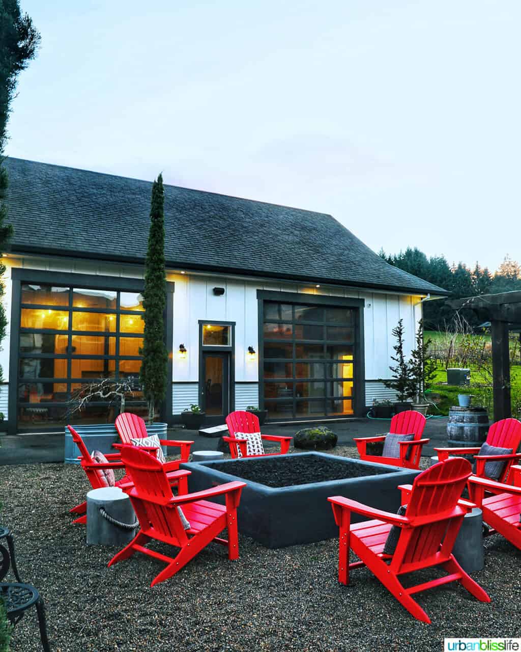 red outdoor chairs around firepit at The Setting Inn Willamette Valley