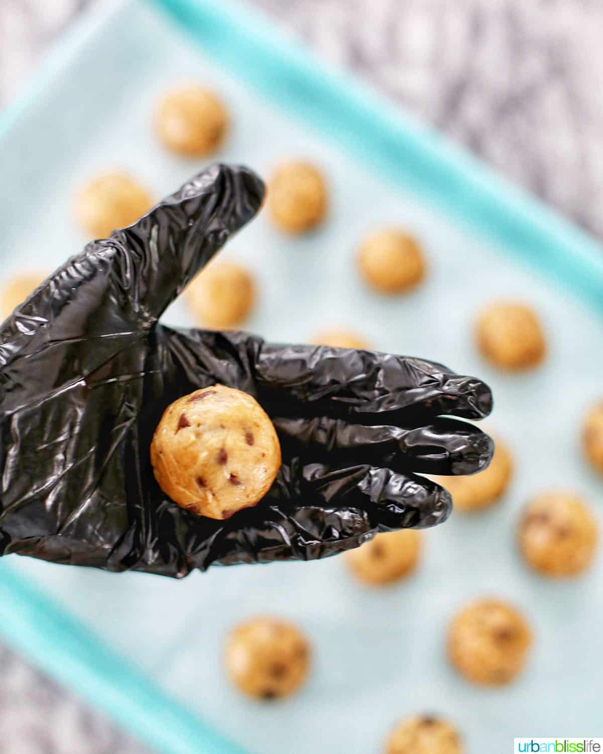 rolled edible cookie dough in hand