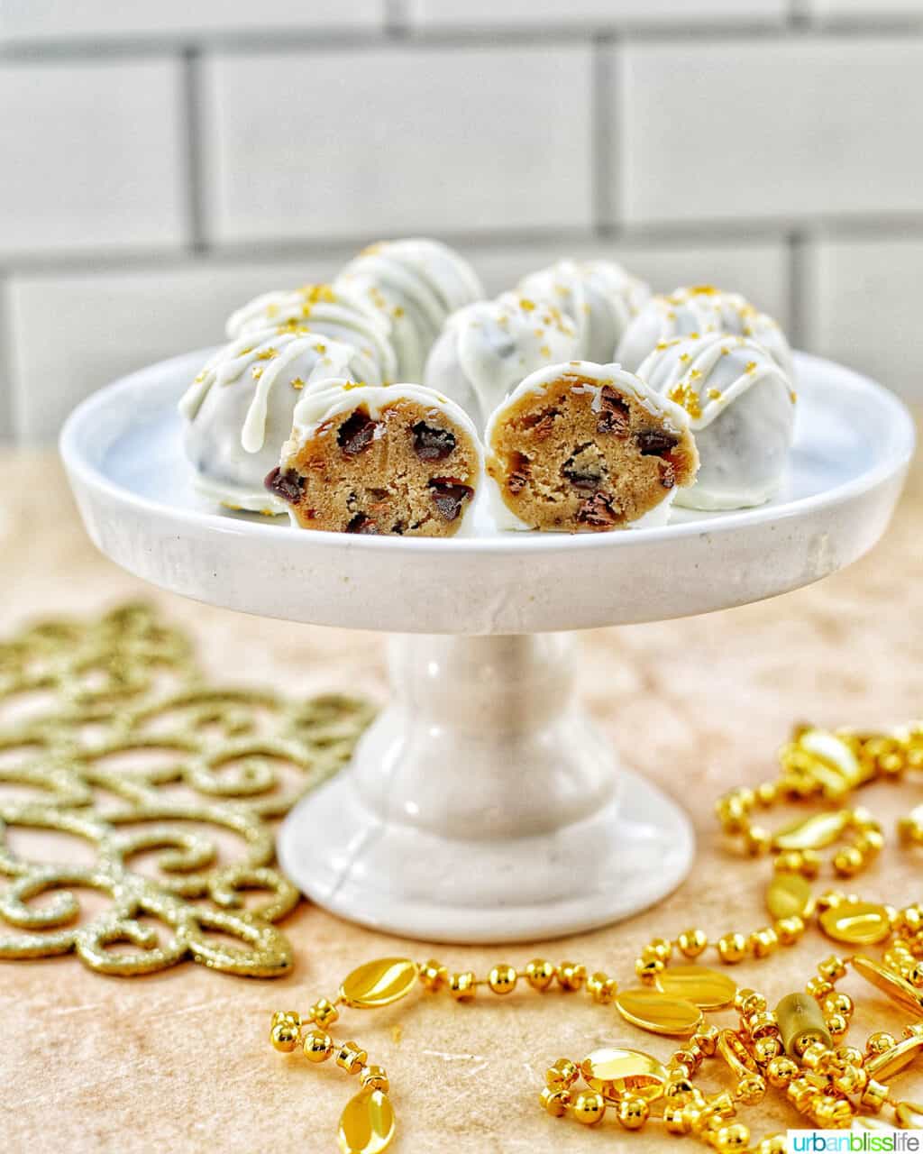 gold decorated white chocolate coated cookie dough truffles cut in half