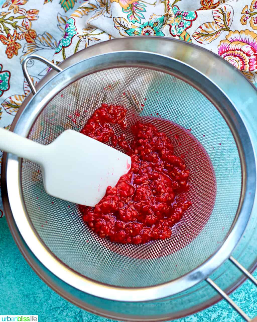 straining raspberries