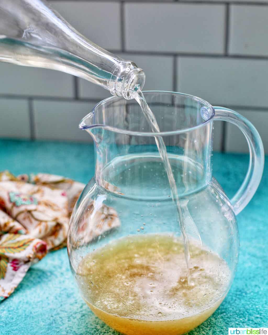 pouring champagne into a pitcher