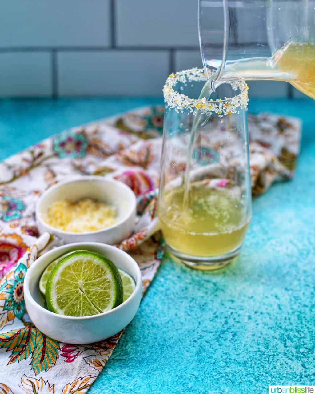 pouring champagne margarita into a glass