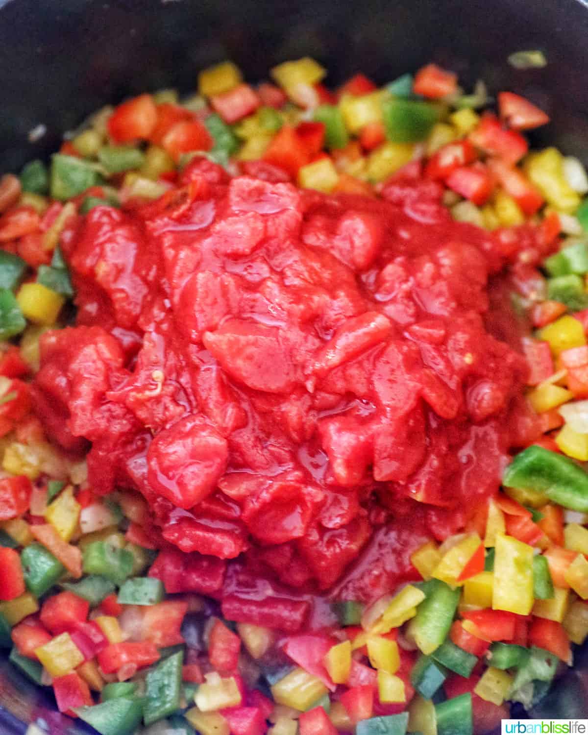 adding tomatoes to peppers to make queso