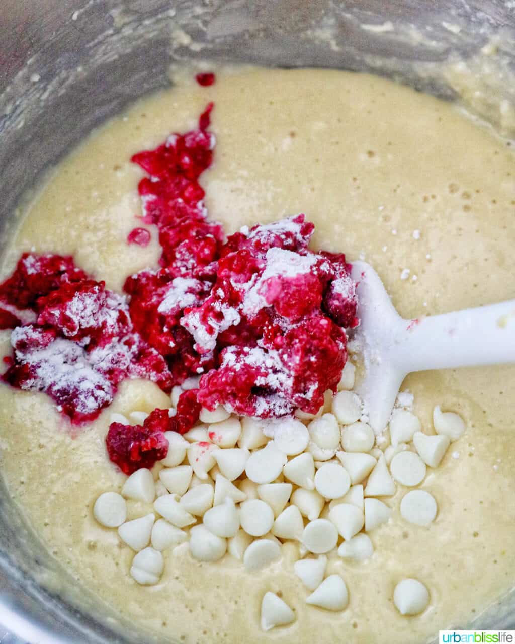 adding raspberries and white chocolate chips to batter