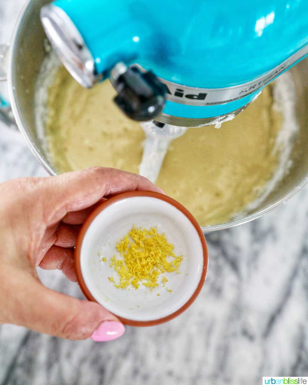 adding lemon zest to cake batter in mixer