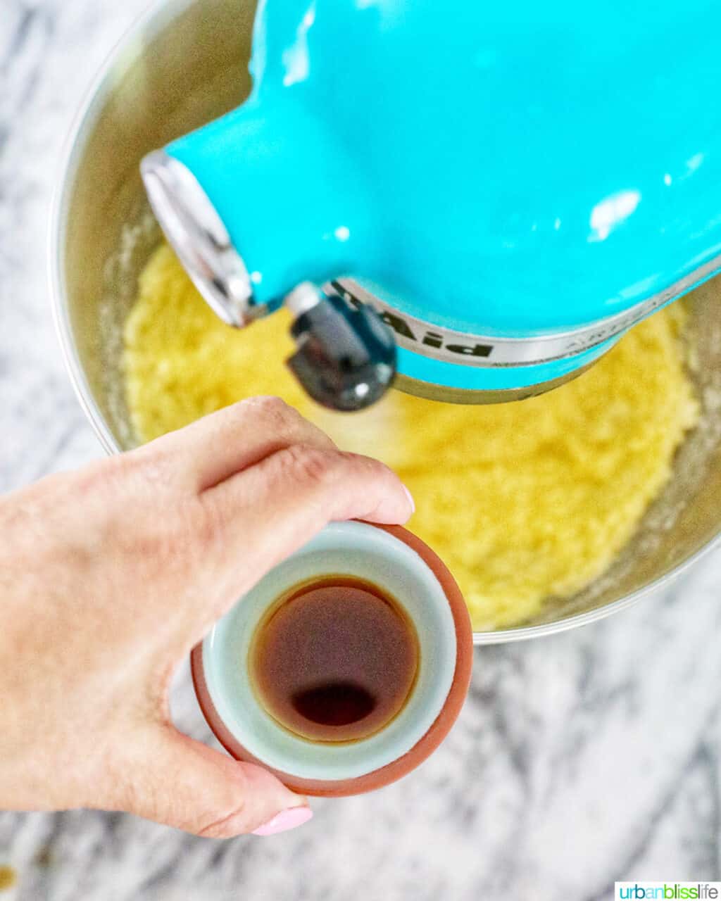 adding vanilla to cake batter in mixer