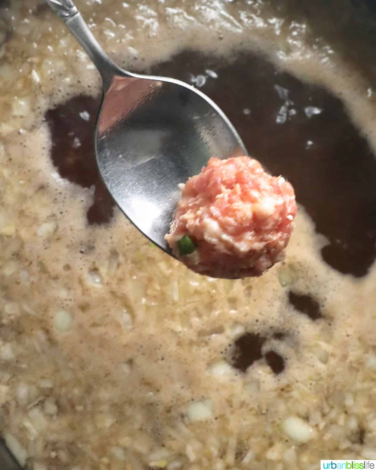 adding meatballs to soup for almondigas