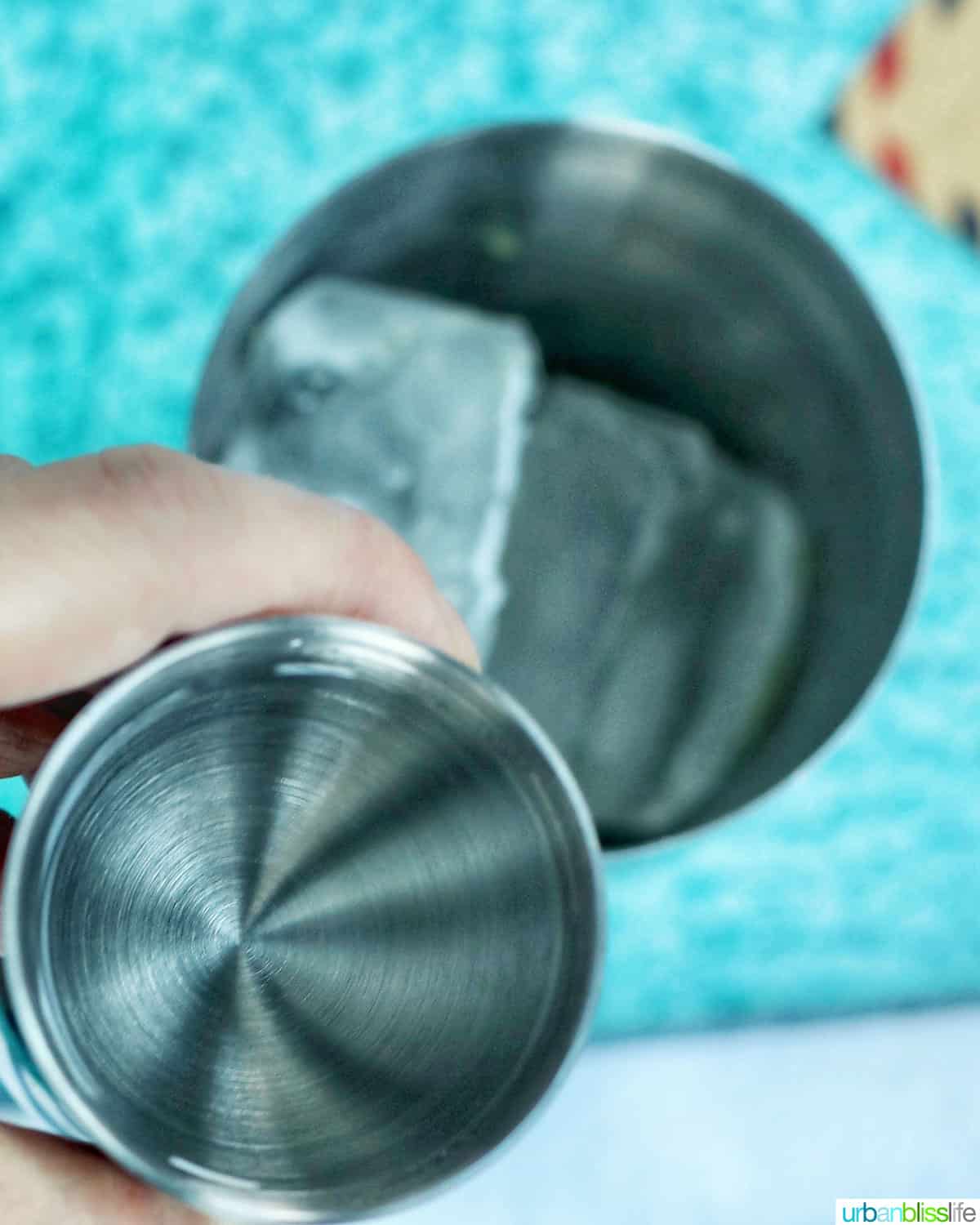 adding rum to cocktail shaker
